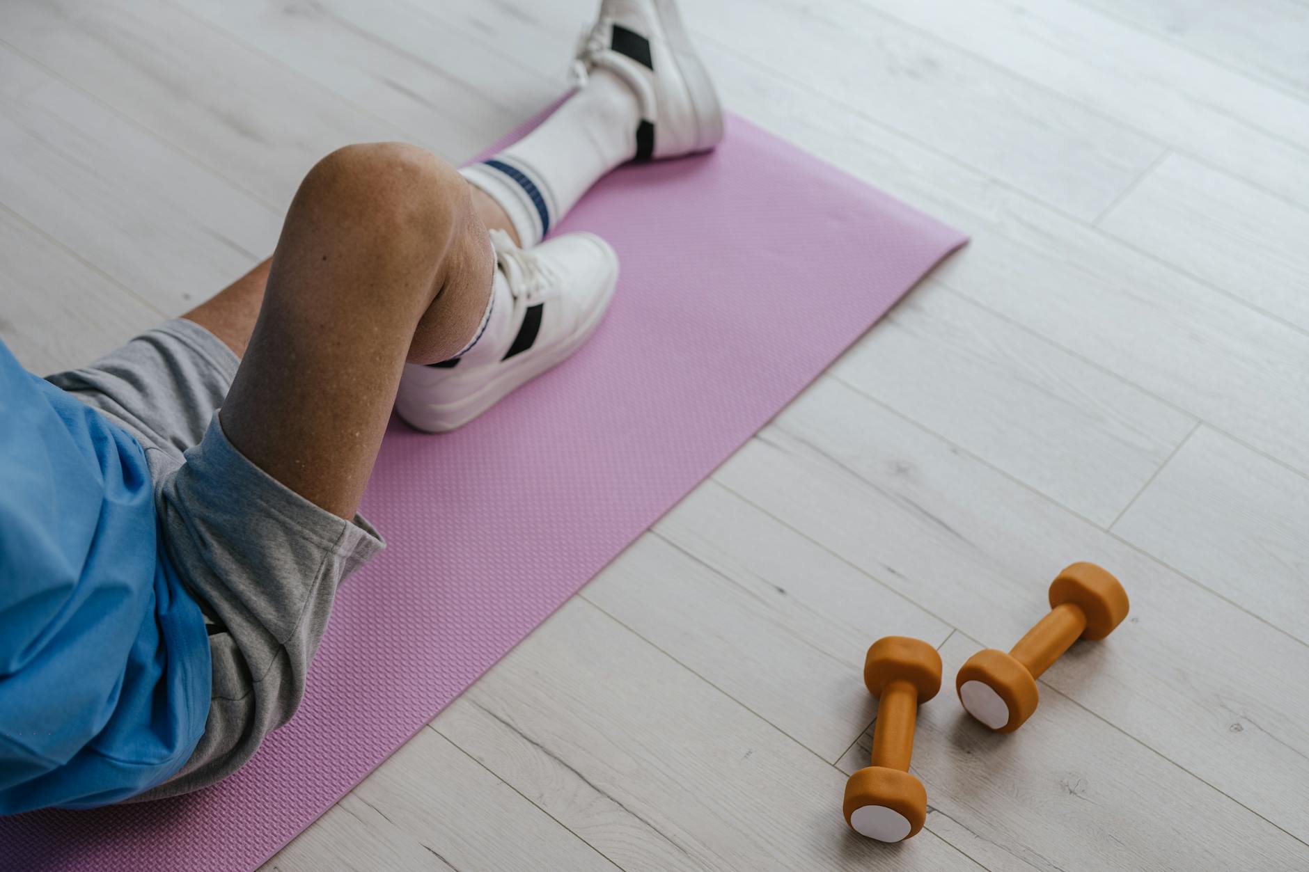 pexels-photo-8899521 a person wearing gray shorts sitting on the yoga mat