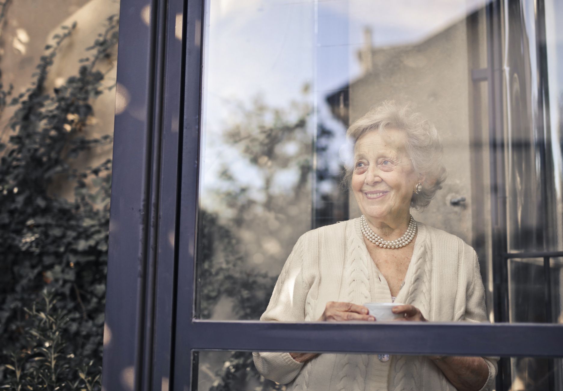 pexels-photo-3768120 woman in white dress shirt standing in front of glass window